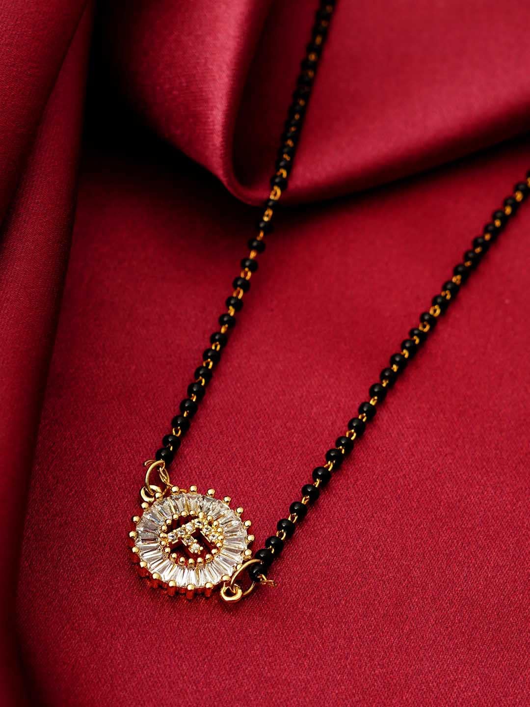 

Ferosh Black & White Gold-Plated Stone Studded & Beaded F Alphabet Mangalsutra