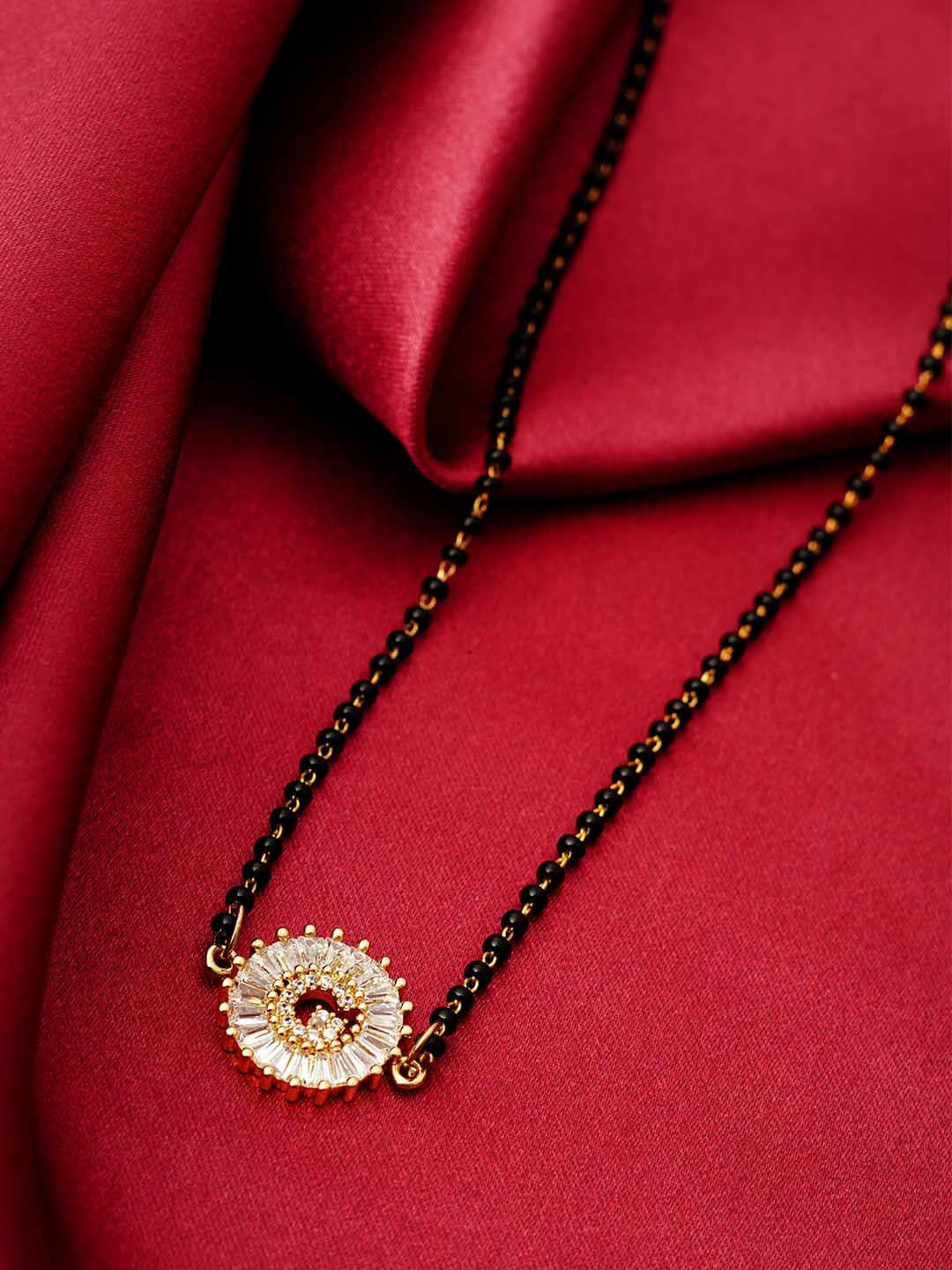 

Ferosh Black & White Gold-Plated Stone Studded & Beaded G Alphabet Mangalsutra