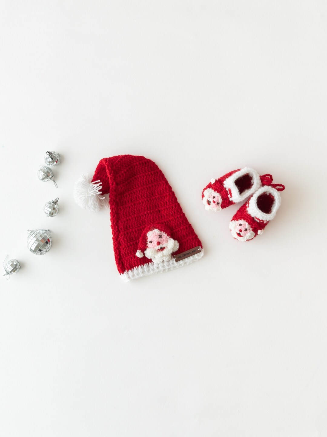 

The Original Knit Kids Red & White Self Design Acrylic Santa Cap With Booties