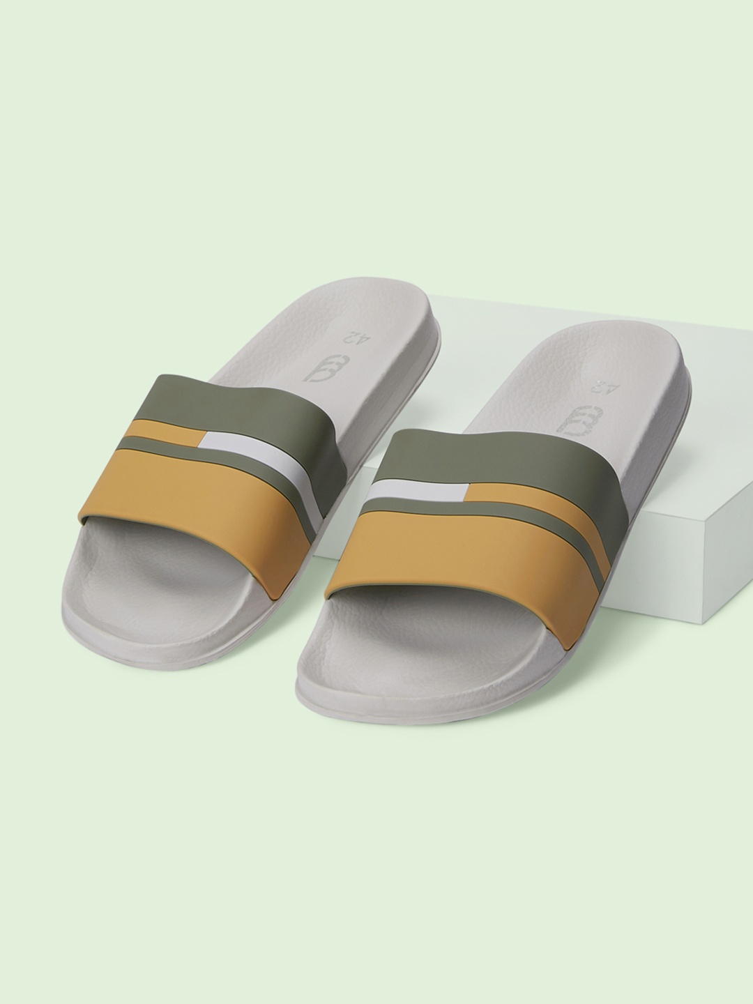 

Ajile by Pantaloons Men Off White & Brown Striped Sliders
