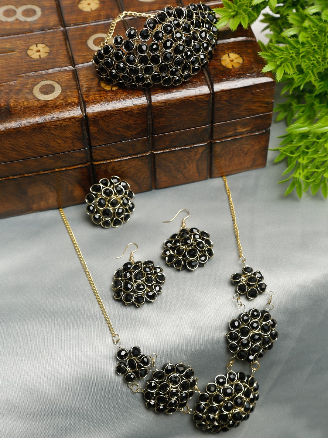 

Dhrohar Gold-Plated Black Artificial Stone Studded Jewellery Set