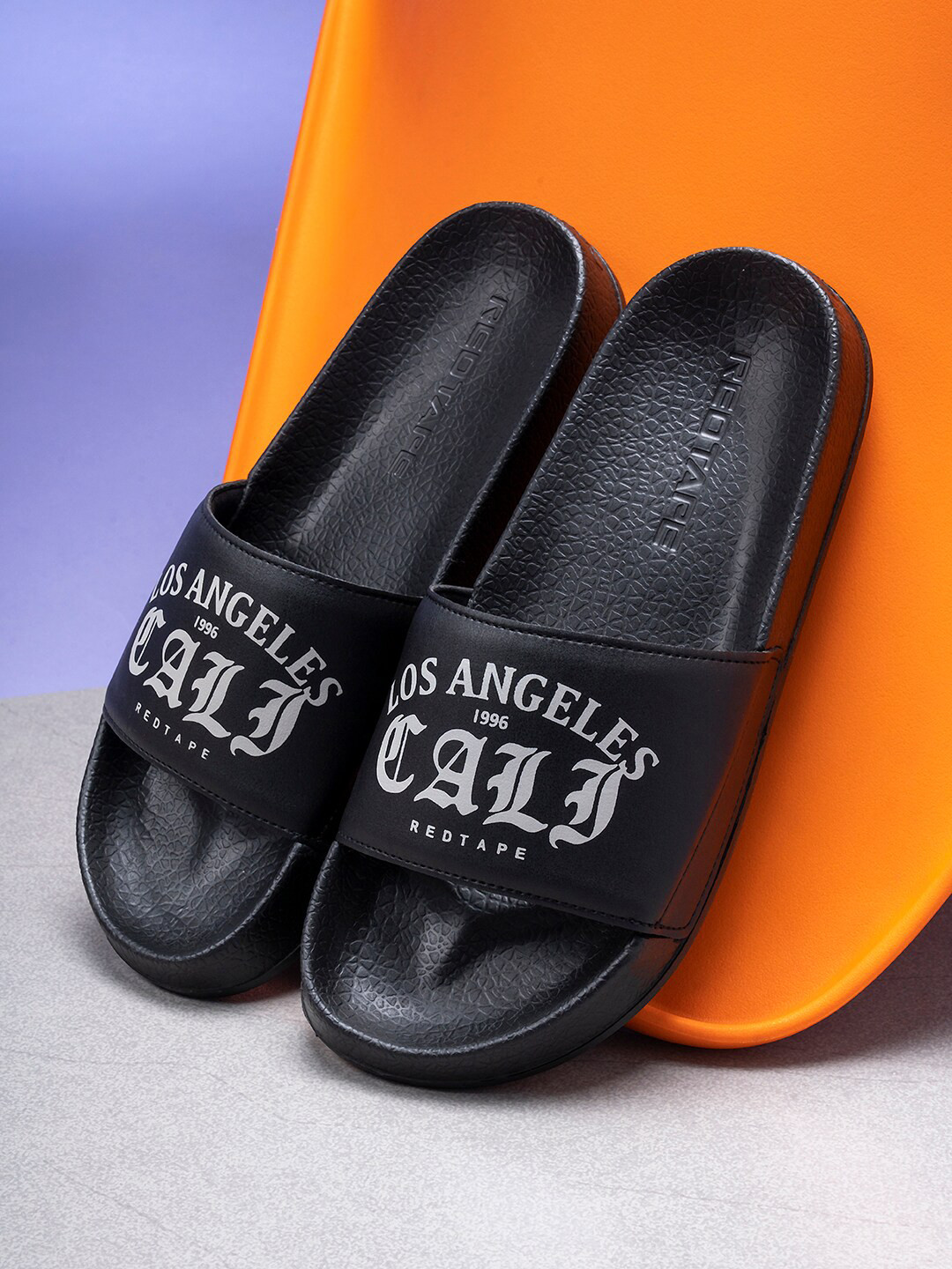 

Red Tape Men Black & White Printed Rubber Sliders