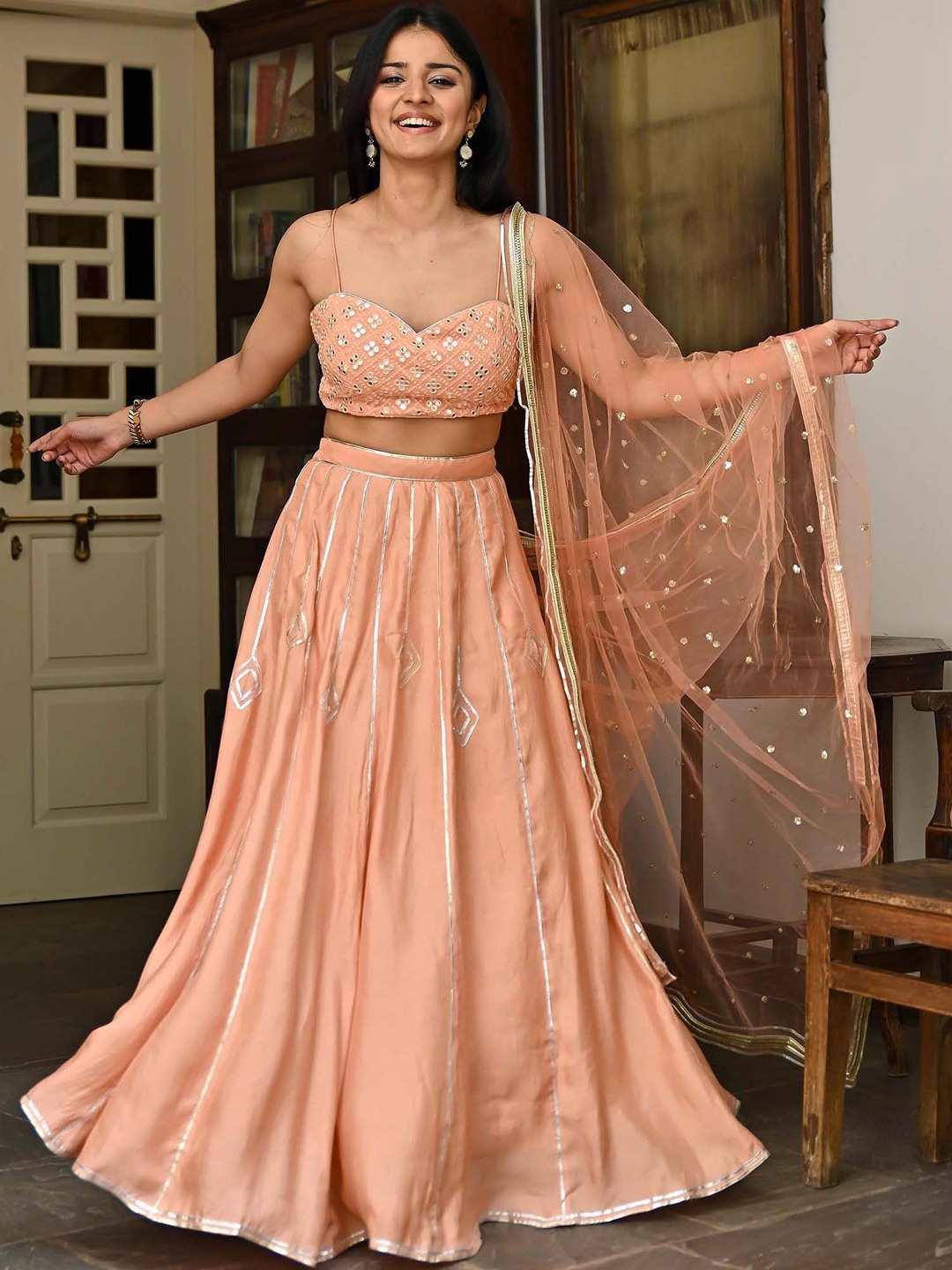 

Lavanya The Label Peach-Coloured & Gold-Toned Embellished Mirror Work Ready to Wear Lehenga & Blouse With