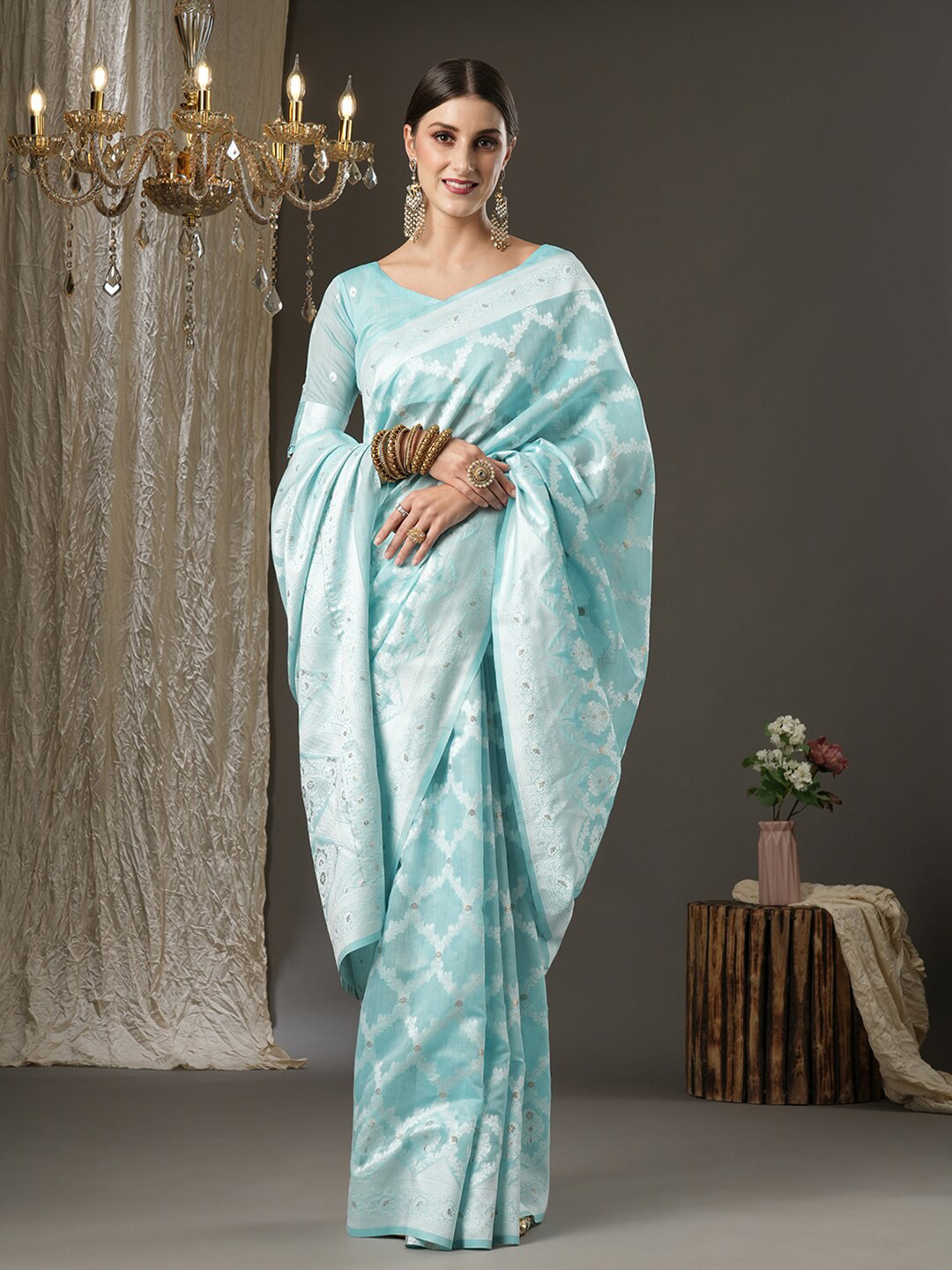 

Mitera Turquoise Blue & Silver-Toned Ethnic Motifs Zari Silk Cotton Banarasi Saree