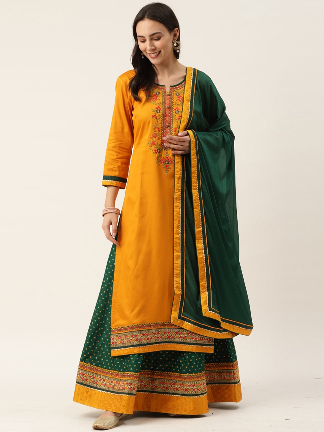 

Kvsfab Women Mustard Yellow Floral Embroidered Kurta with Skirt & Dupatta