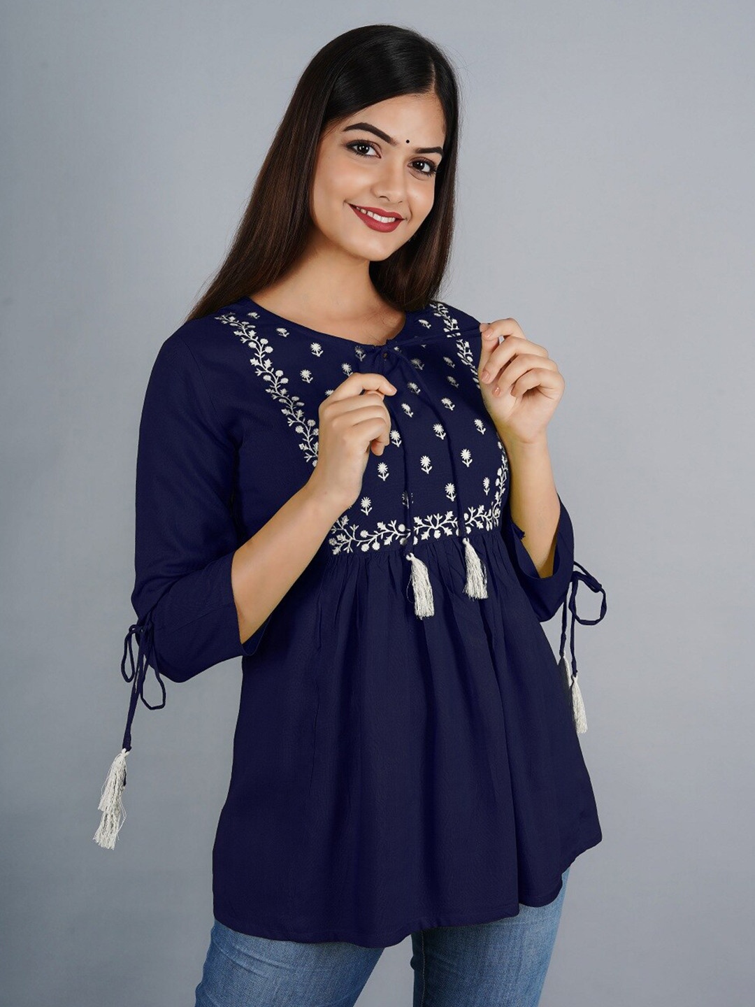

Ashlee Women Blue & White Floral Embroidered Tie-Up Neck Empire Top