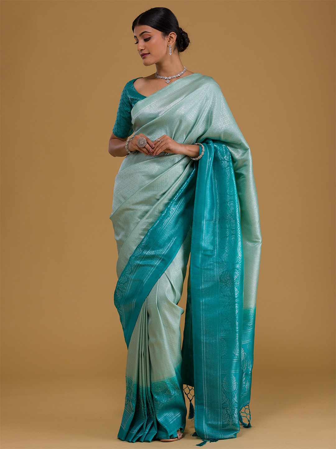 

Koskii Sea Green & Silver-Toned Ethnic Motifs Zari Banarasi Saree