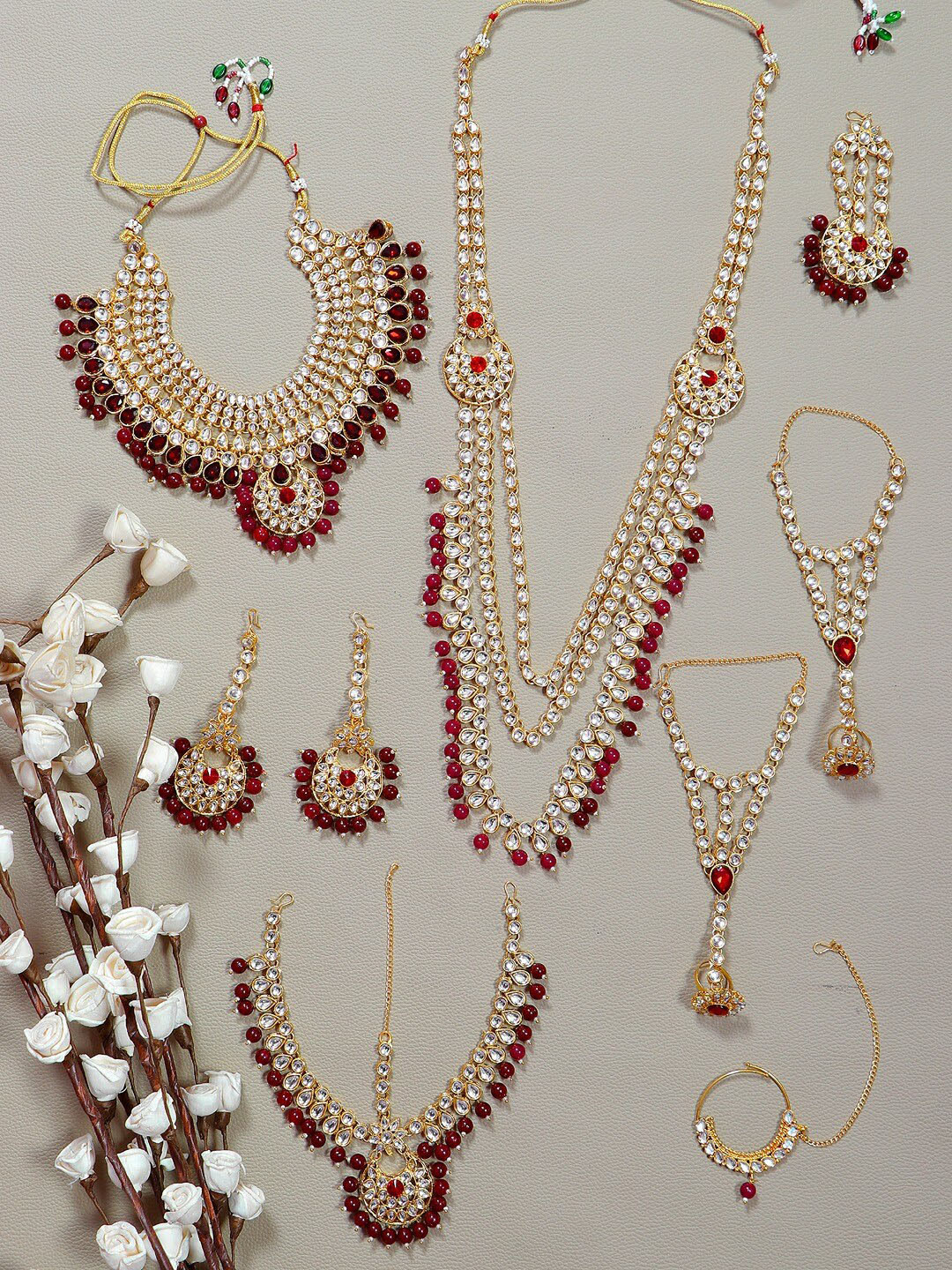 

Crunchy Fashion Gold Plated Maroon & White Kundan Studded Jewellery Set