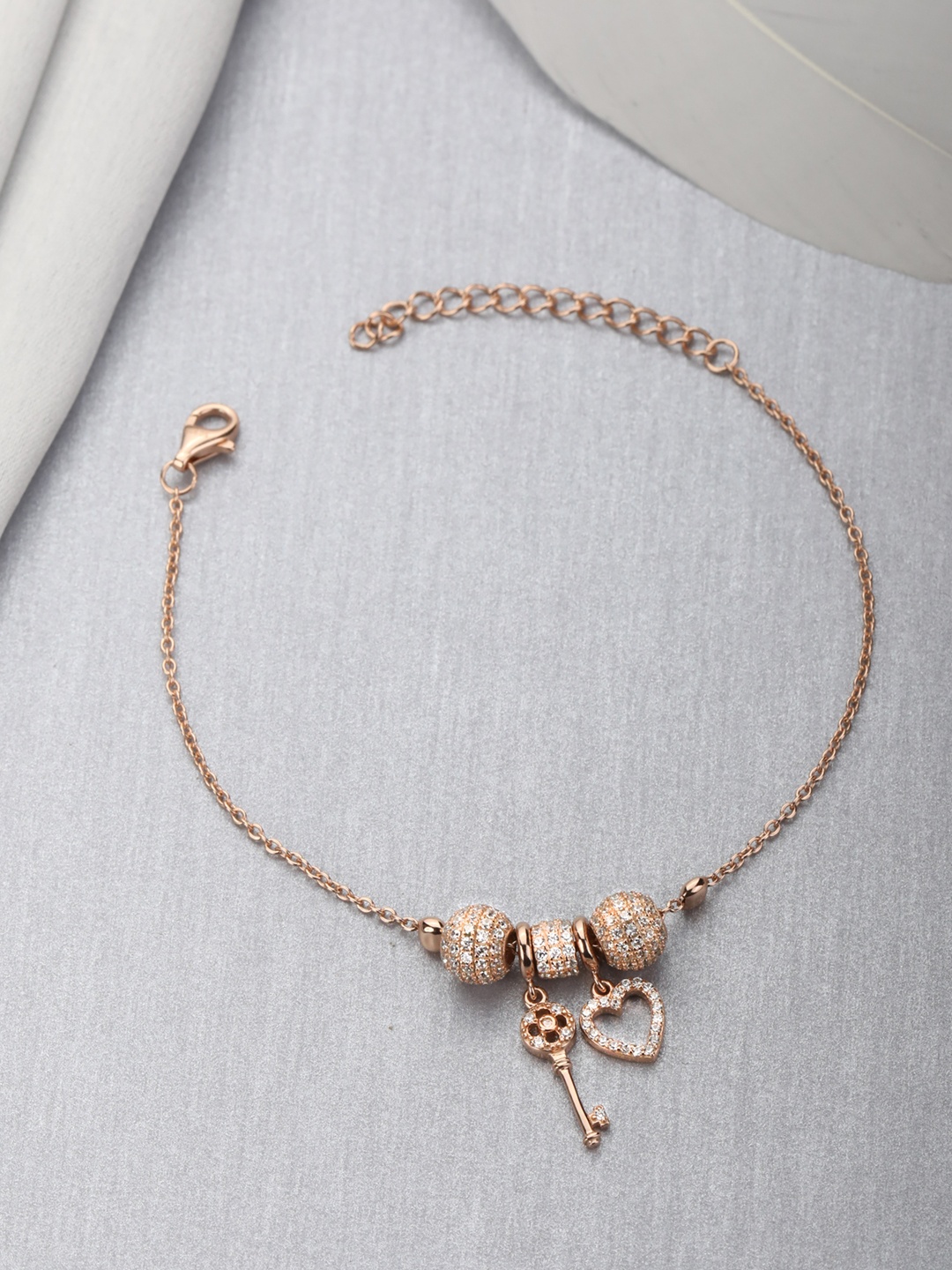 

Zavya Women Gold-Toned Silver Cubic Zirconia Rose Gold-Plated Charm Bracelet