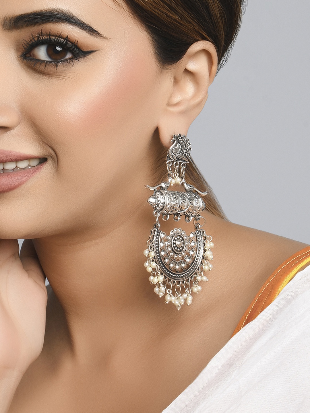 

Fida White Silver Plated Peacock Shaped Chandbalis Earrings