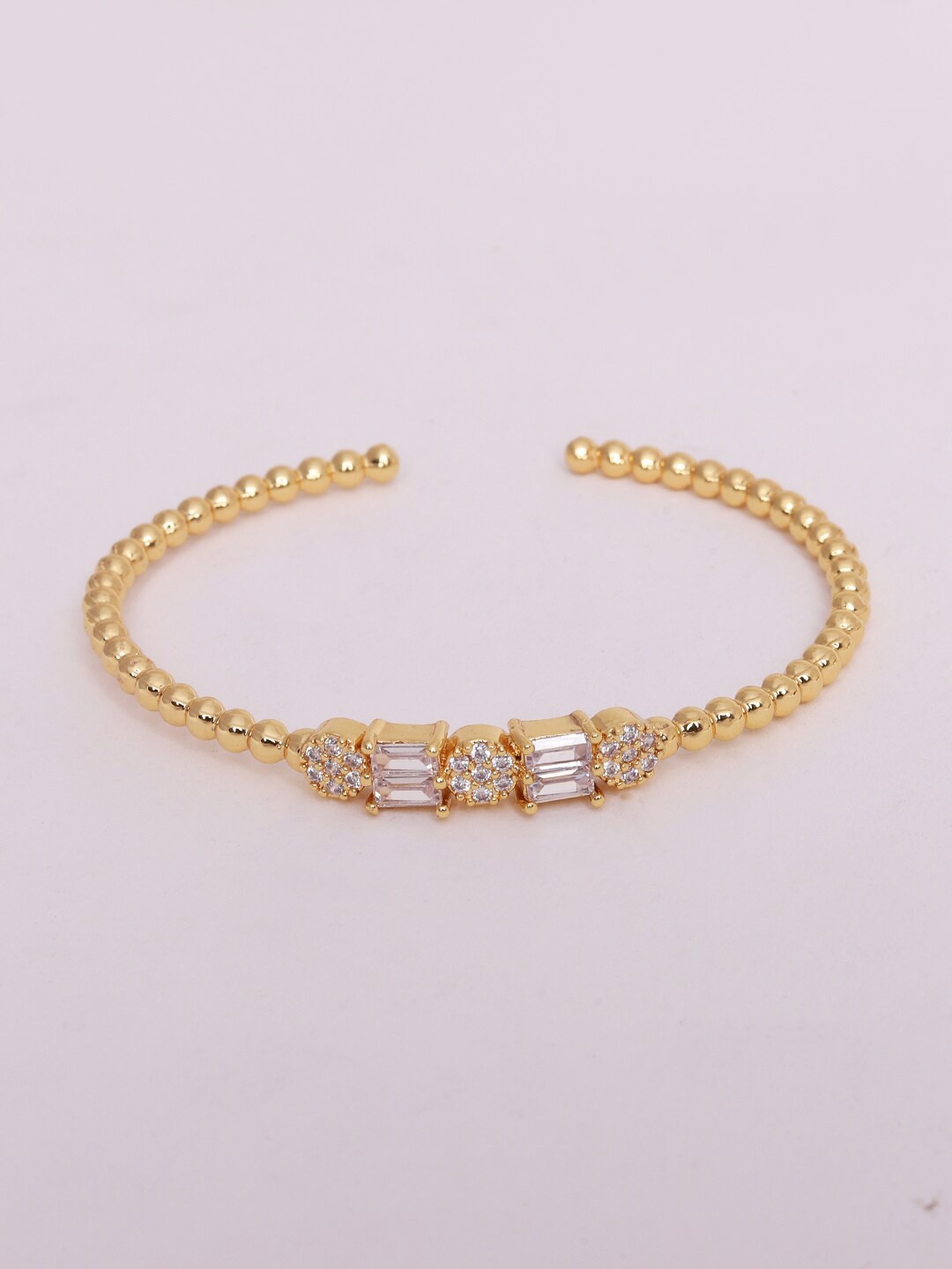 

Ikram Women Gold-Toned & White Brass Cubic Zirconia Gold-Plated Cuff Bracelet