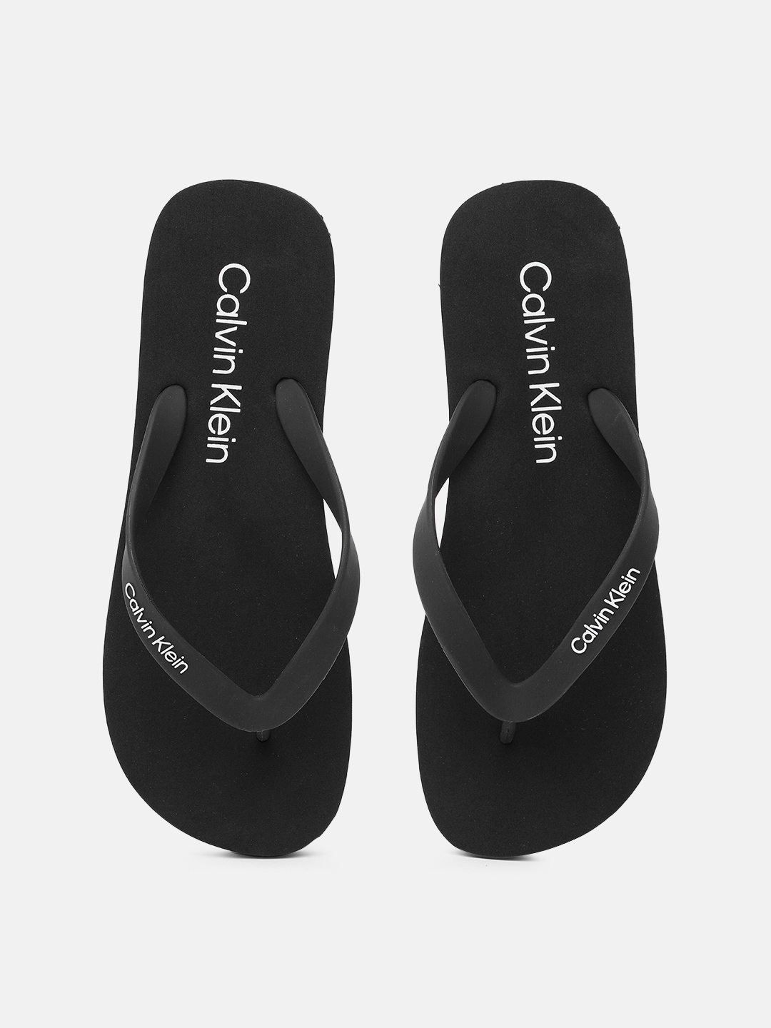 

Calvin Klein Jeans Men Brand Logo Print Thong Flip-Flops, Black