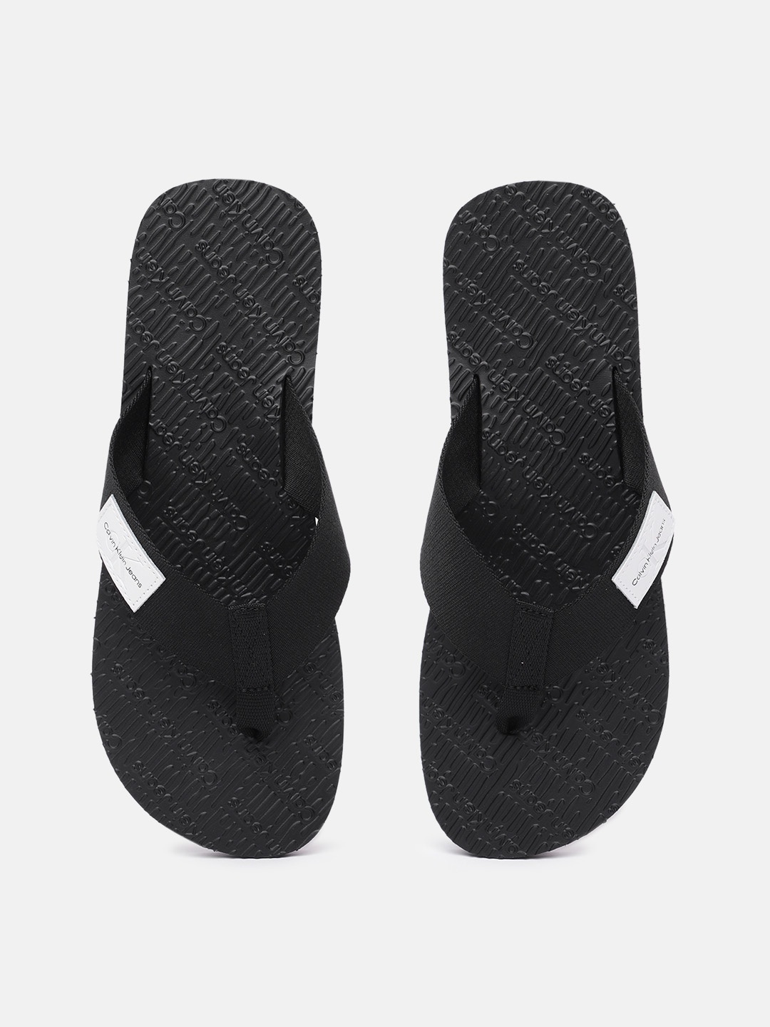 

Calvin Klein Jeans Men Solid Thong Flip-Flops With Brand Logo Applique Detail, Black