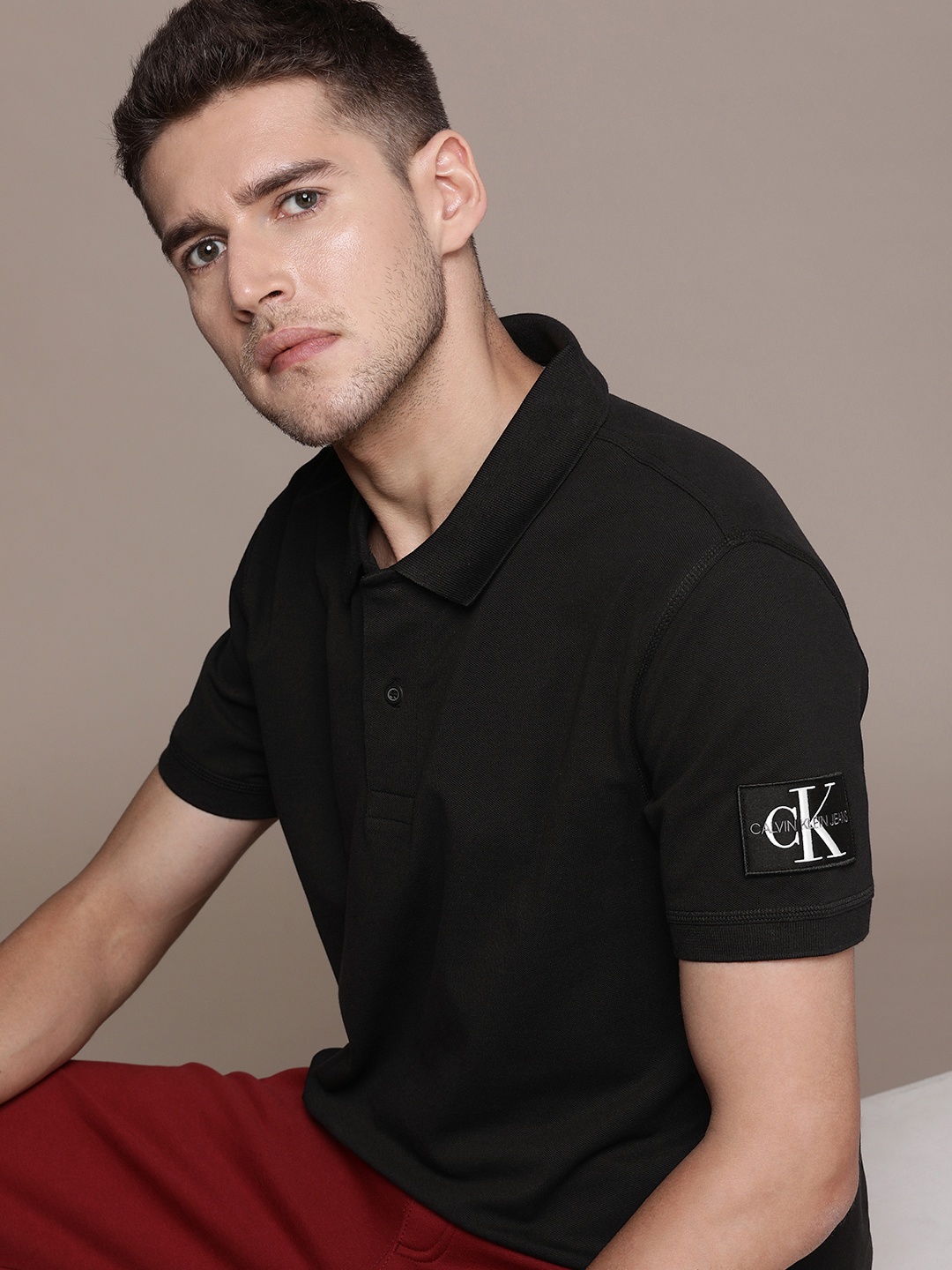 

Calvin Klein Jeans Men Solid Polo Collar T-shirt With Applique Detail, Black