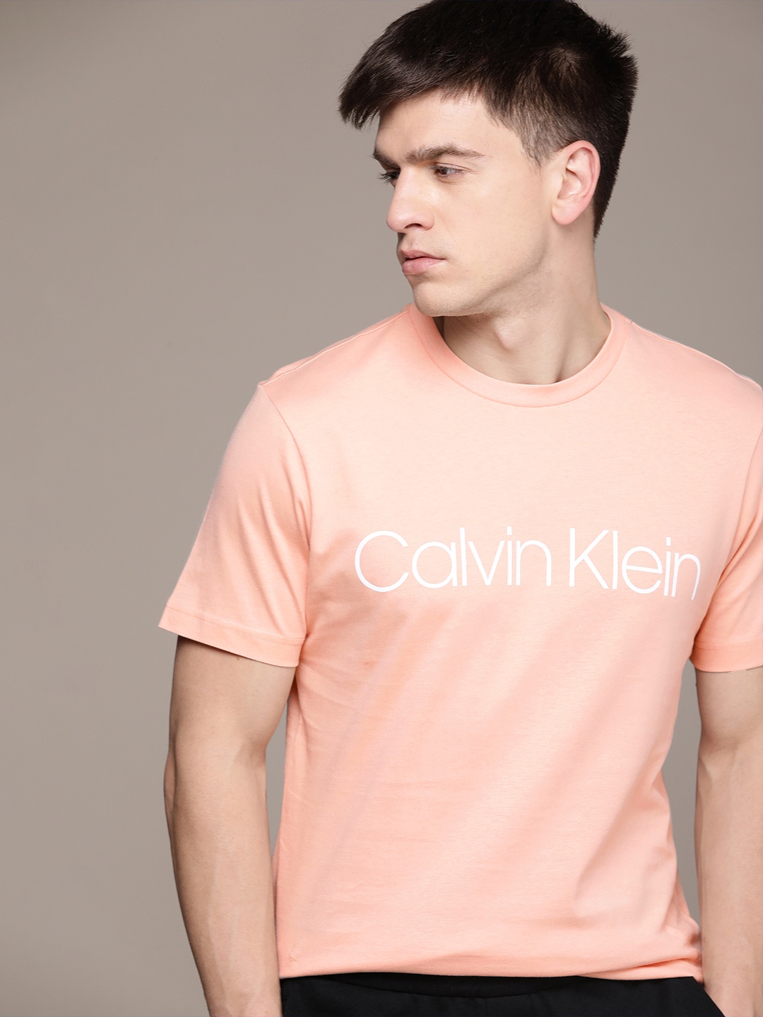 

Calvin Klein Jeans Men Pure Cotton Brand Logo Printed T-shirt, Peach