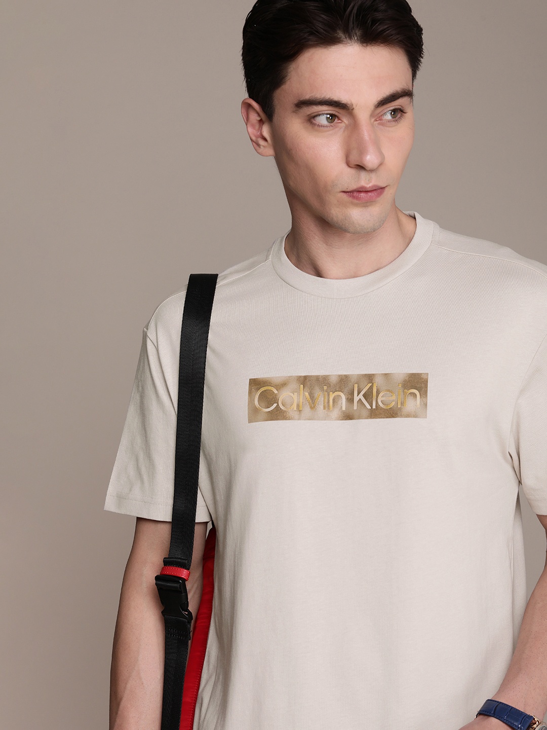 

Calvin Klein Jeans Men Pure Cotton Brand Logo Printed Drop-Shoulder Sleeves T-shirt, Beige