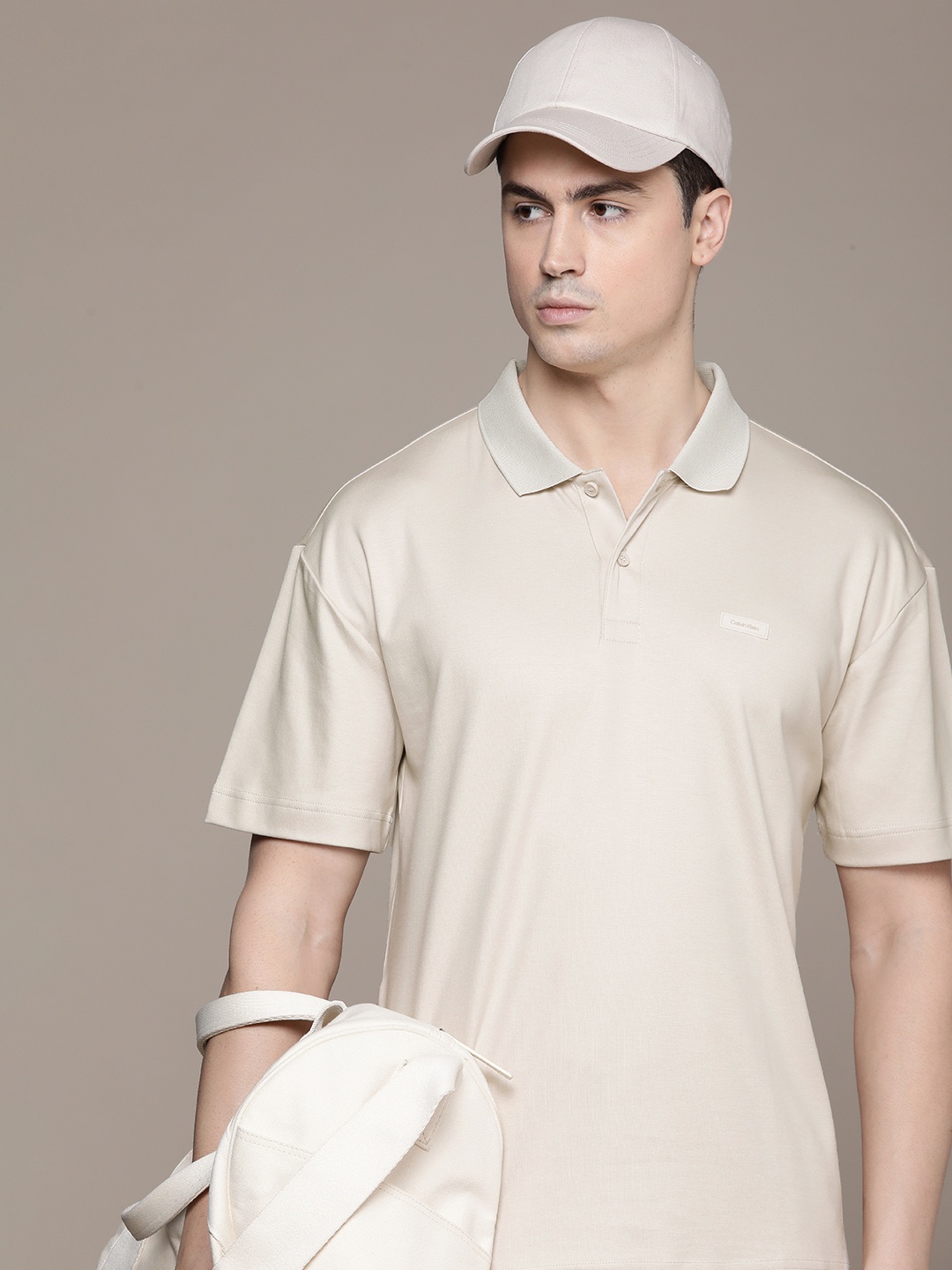 

Calvin Klein Jeans Men Polo Collar Drop-Shoulder Sleeves Pure Cotton Applique T-shirt, Beige