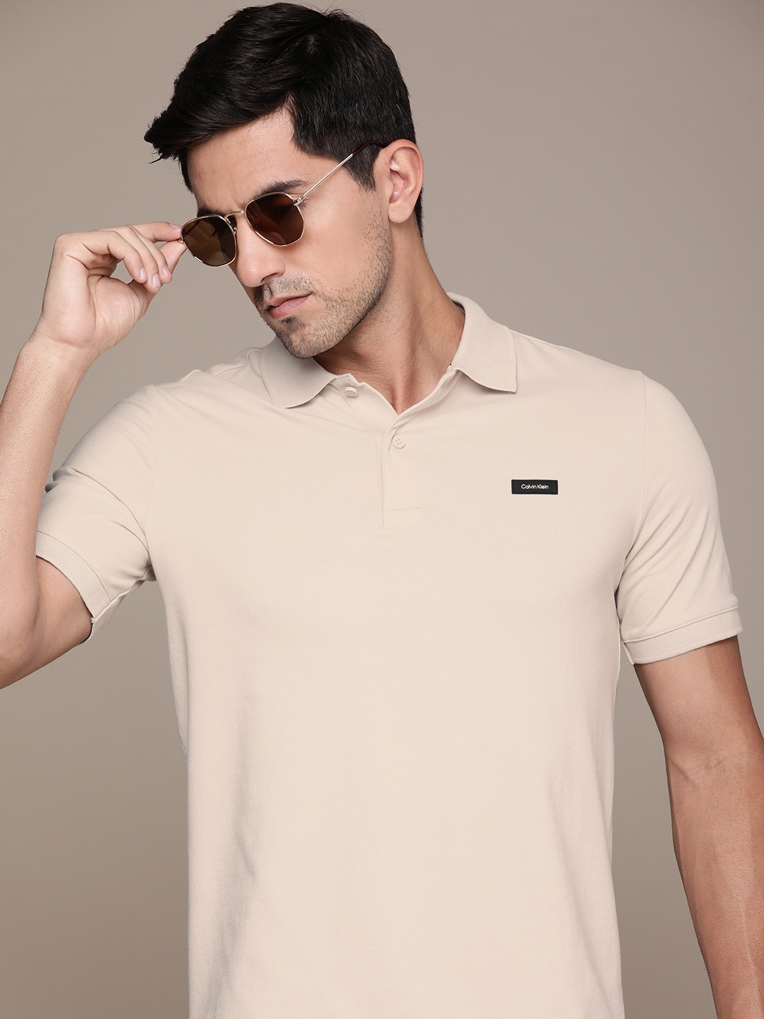 

Calvin Klein Jeans Men Solid Polo Collar T-shirt with Applique Detail, Taupe