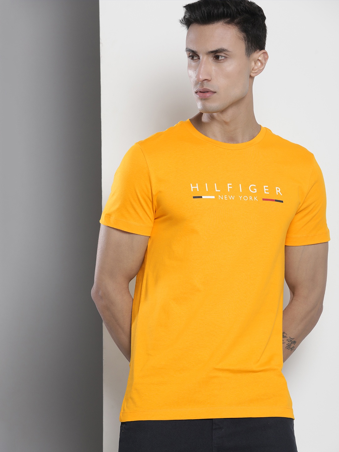 

Tommy Hilfiger Men Pure Cotton Sustainable Brand Logo Printed Slim Fit T-shirt, Mustard