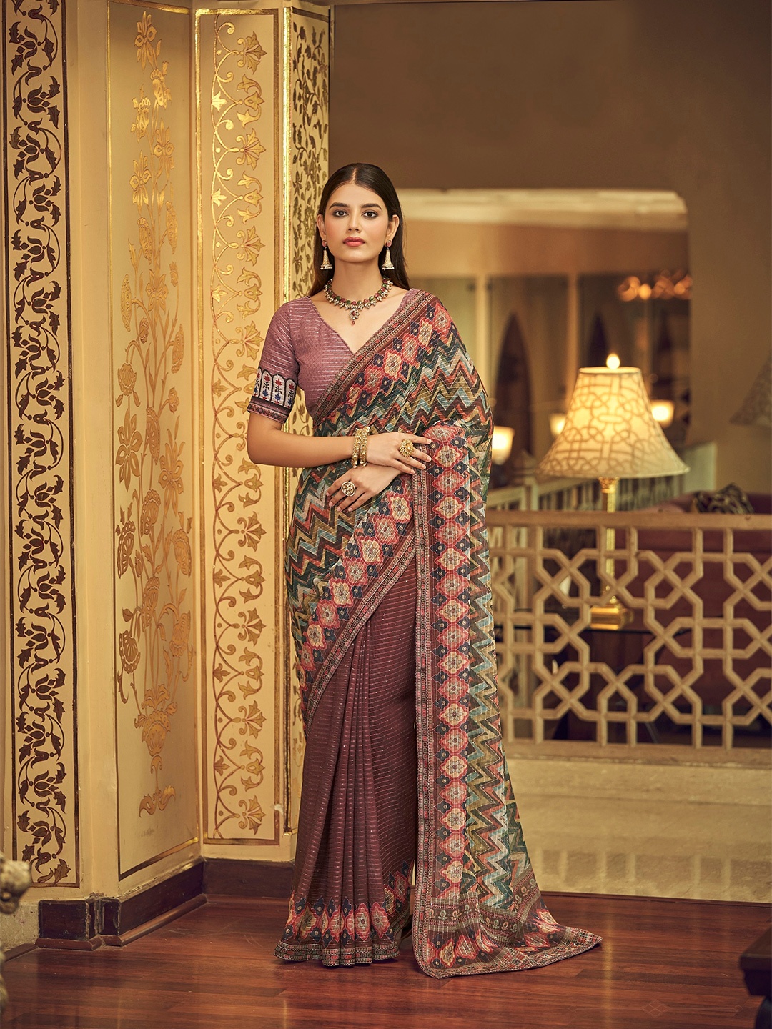 

Vrundavan ethics Mauve & Orange Sequinned Pure Georgette Leheriya Saree