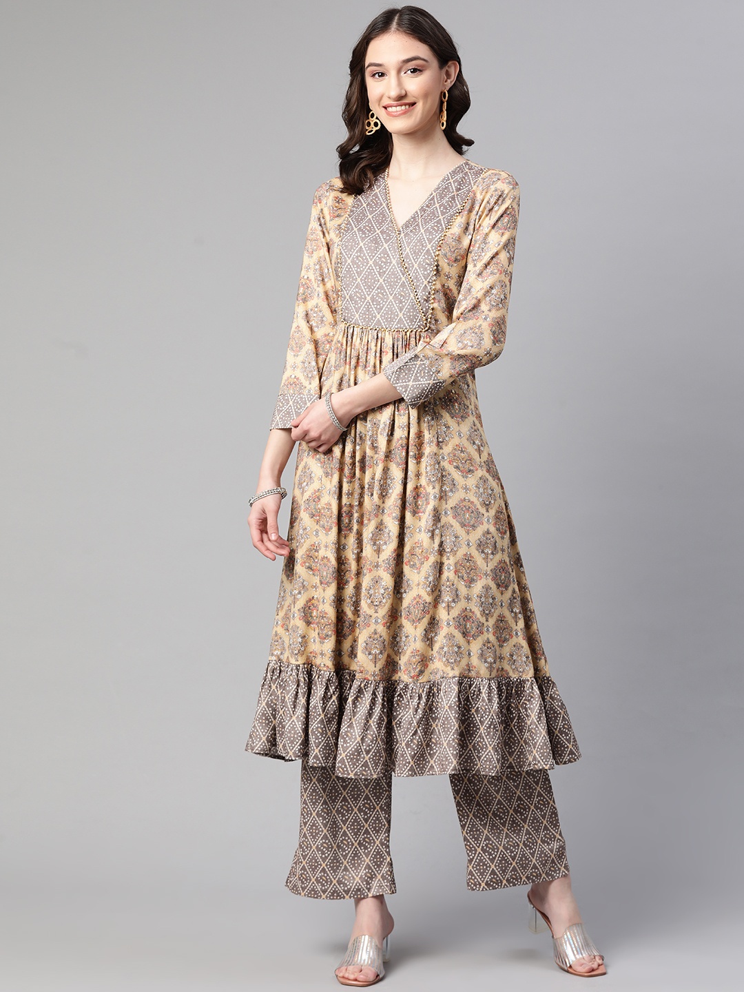 

Cottinfab Women Beige Floral Printed Panelled Beads and Stones Kurta with Trousers