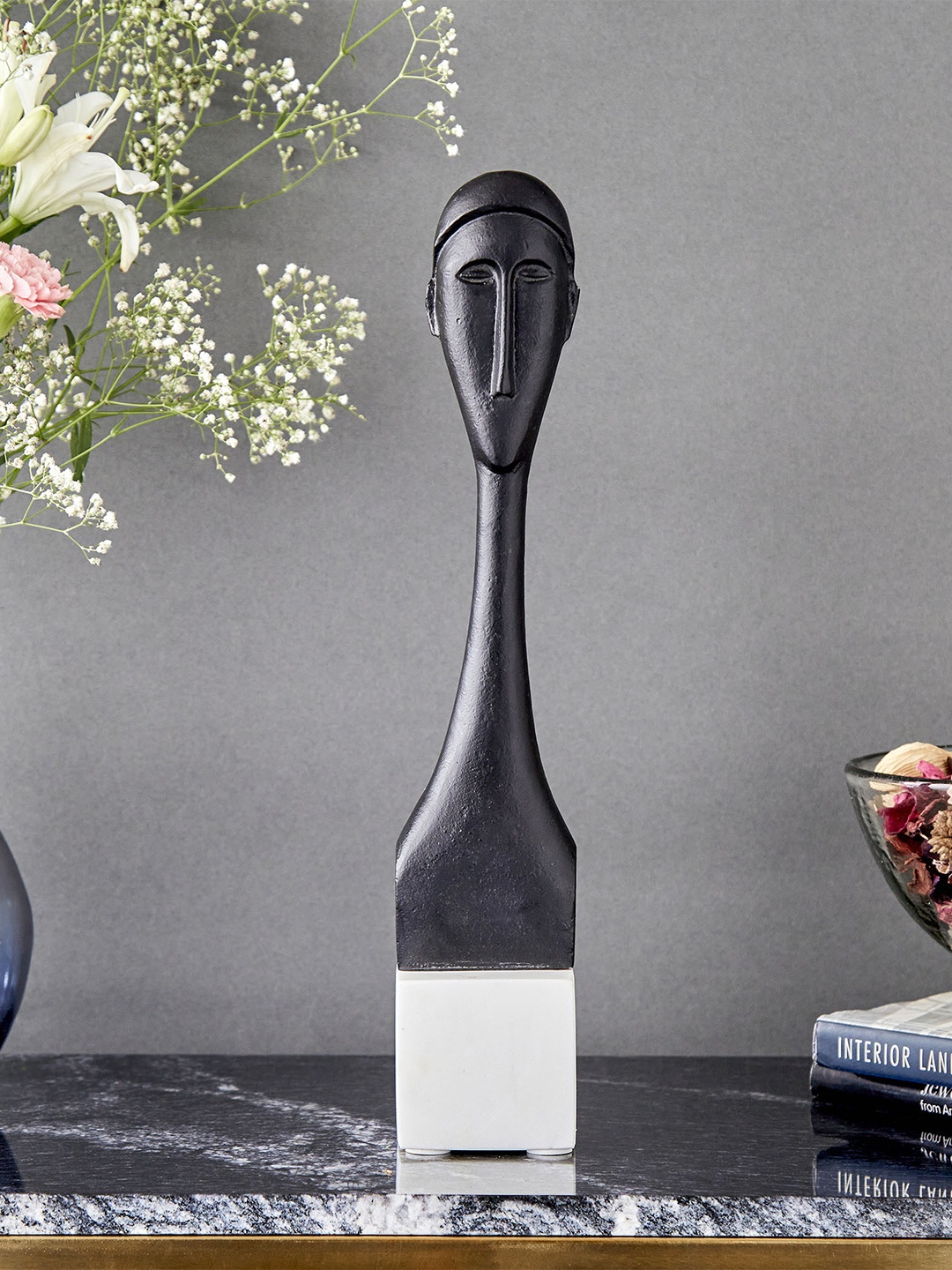 

Home Centre Eternity Black Textured Tribal Face Aluminium Showpiece