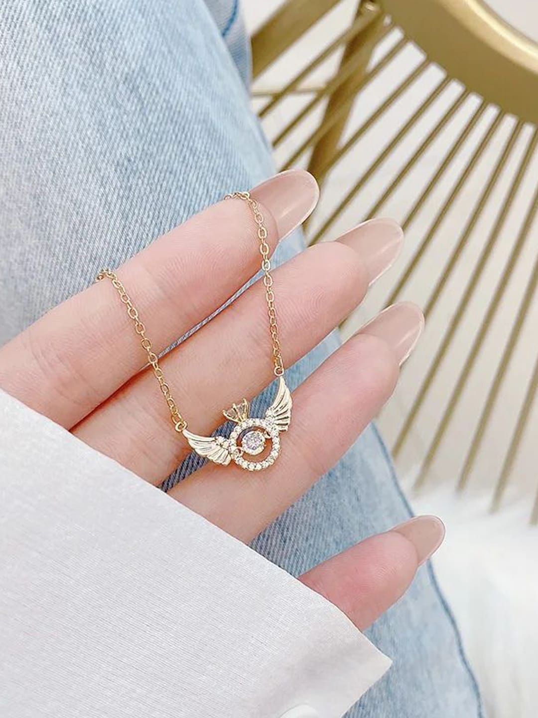 

Designs By Jewels Galaxy Gold-Plated Stone-Studded Angel Wings Pendant With Chain