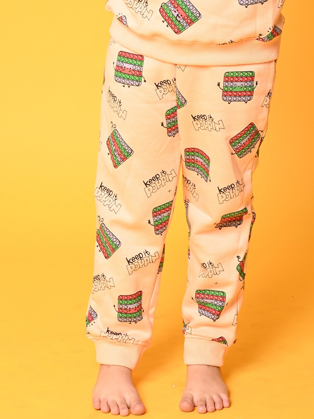 

Anthrilo Girls Printed Fleece Joggers, Peach