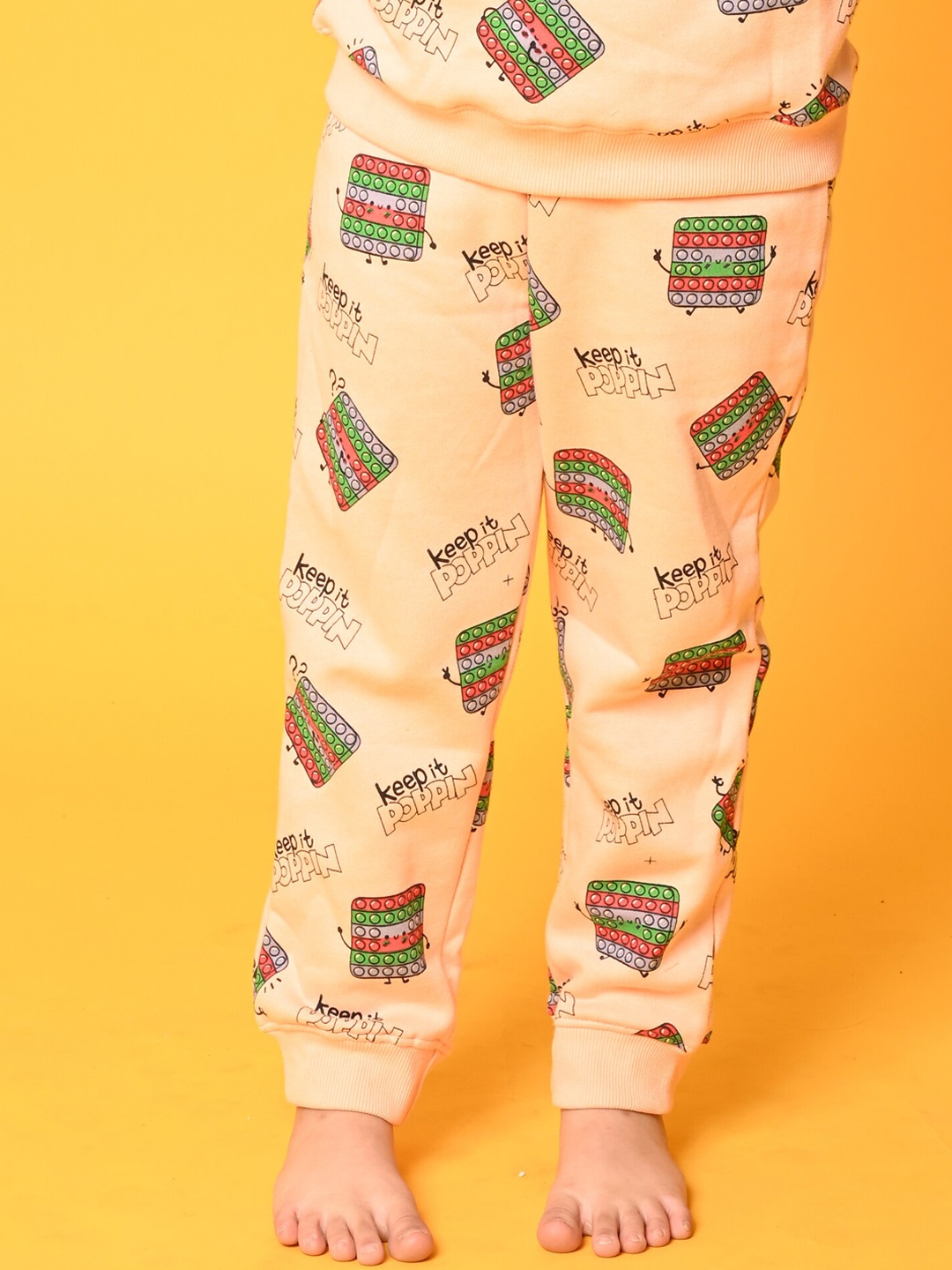 

Anthrilo Girls Printed Fleece Joggers, Peach