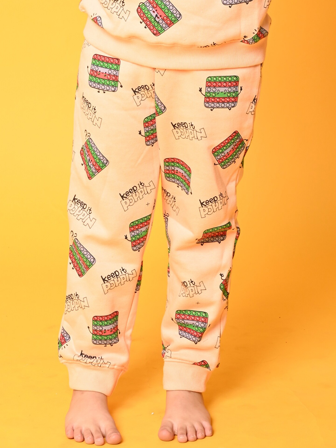 

Anthrilo Girls Printed Fleece Joggers, Peach