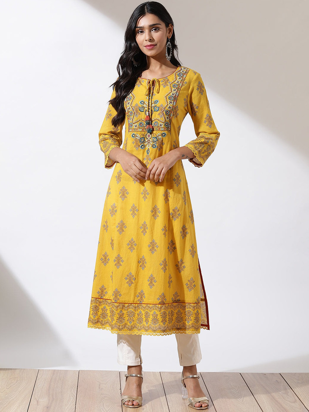 

Lakshita Women Ethnic Motifs Printed Thread Work Tie-Up Neck Kurta, Mustard