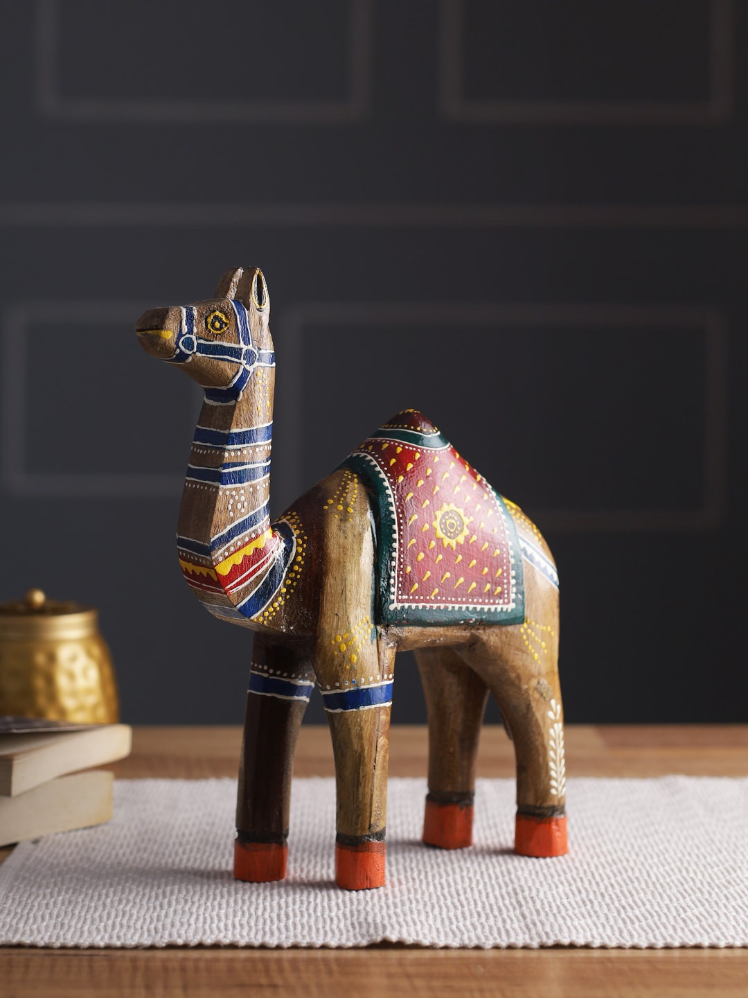 

Aapno Rajasthan Brown & Red Wooden Camel Showpieces