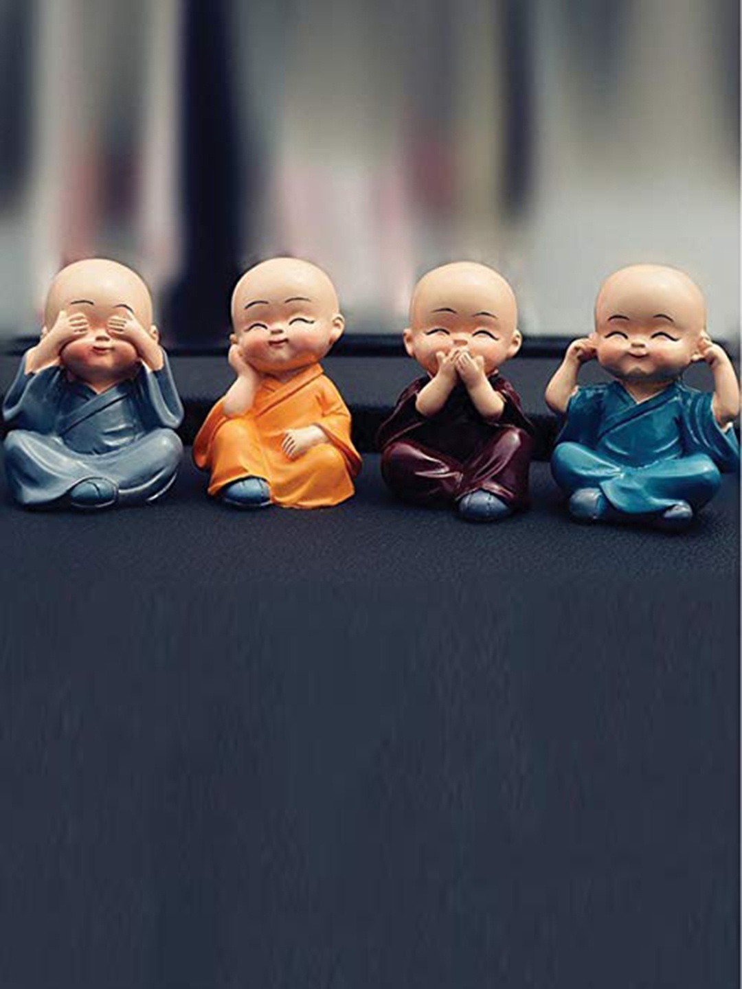 

Perpetual Set Of 4 Orange & Blue Resin Buddha Monk Statues