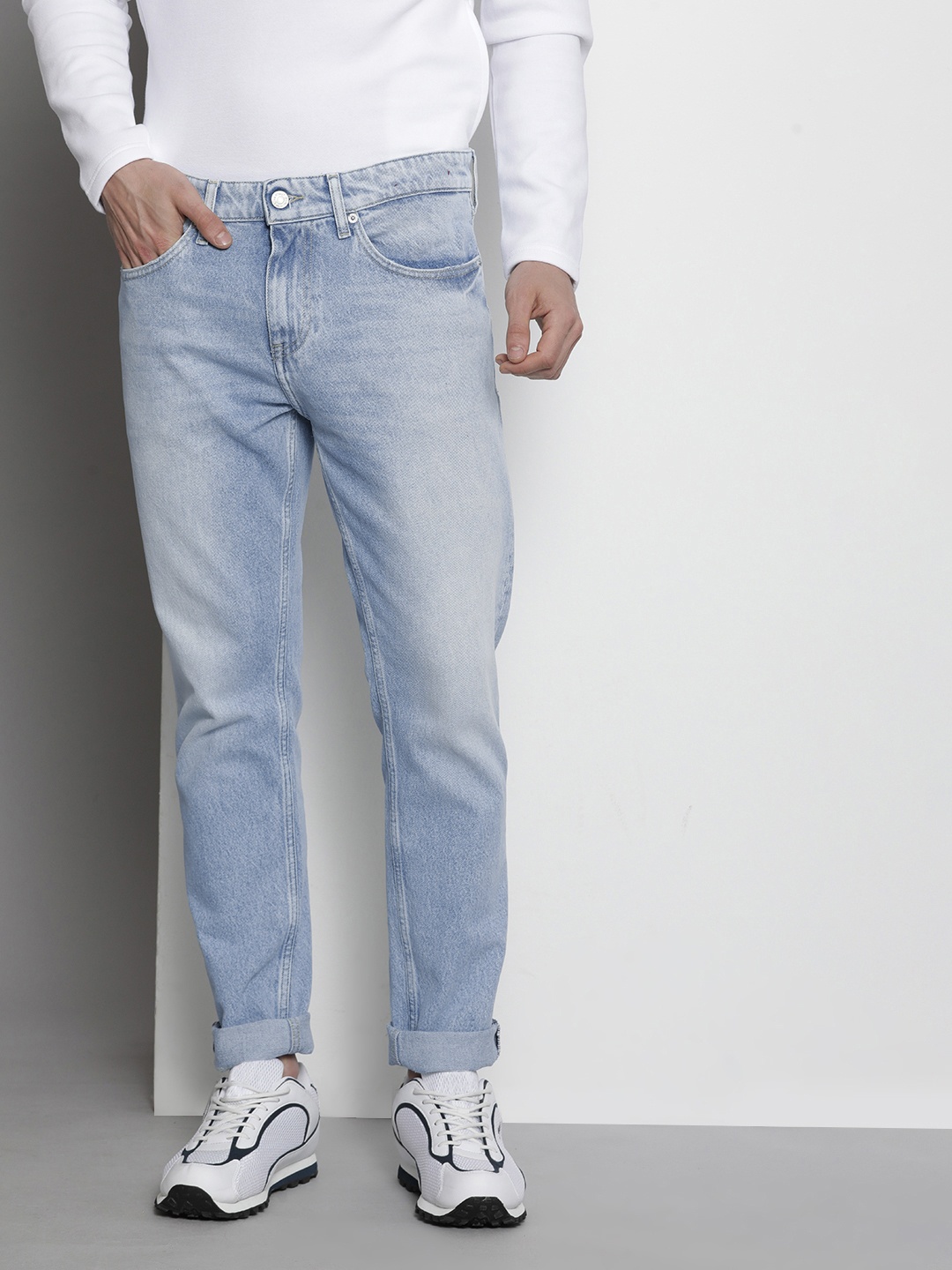 

Tommy Hilfiger Men Tapered Fit Heavy Fade Acid Wash Jeans, Blue