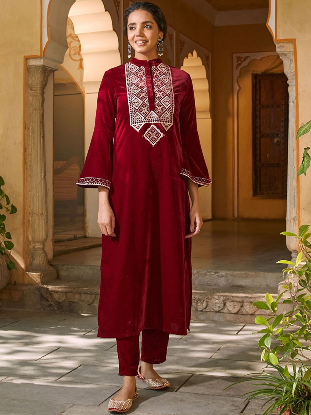 

Rustorange Women Ethnic Motifs Embroidered Bell Sleeves Indie Prints Velvet Kurta, Red