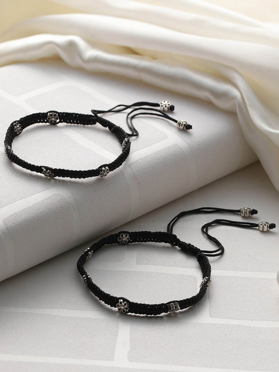 

Priyaasi Set Of 2 Sliver-Plated Floral Design Black Threaded Anklet, Silver