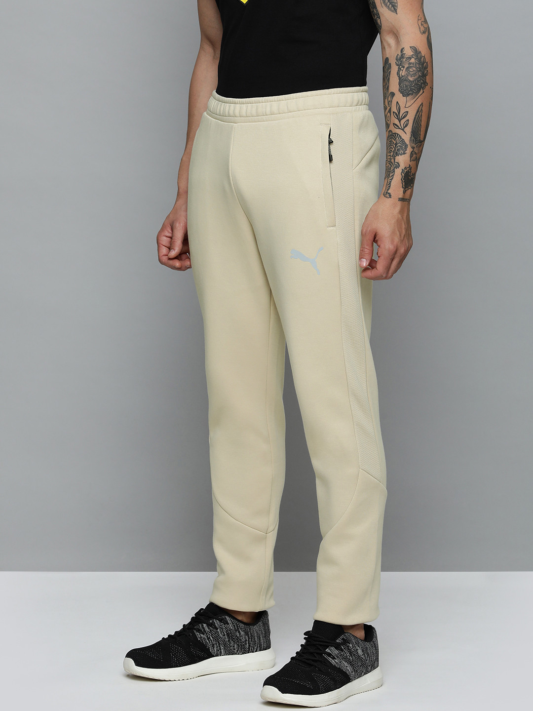 

Puma Men Solid Mid Rise EVOSTRIPE Slim Fit Track Pants, Beige