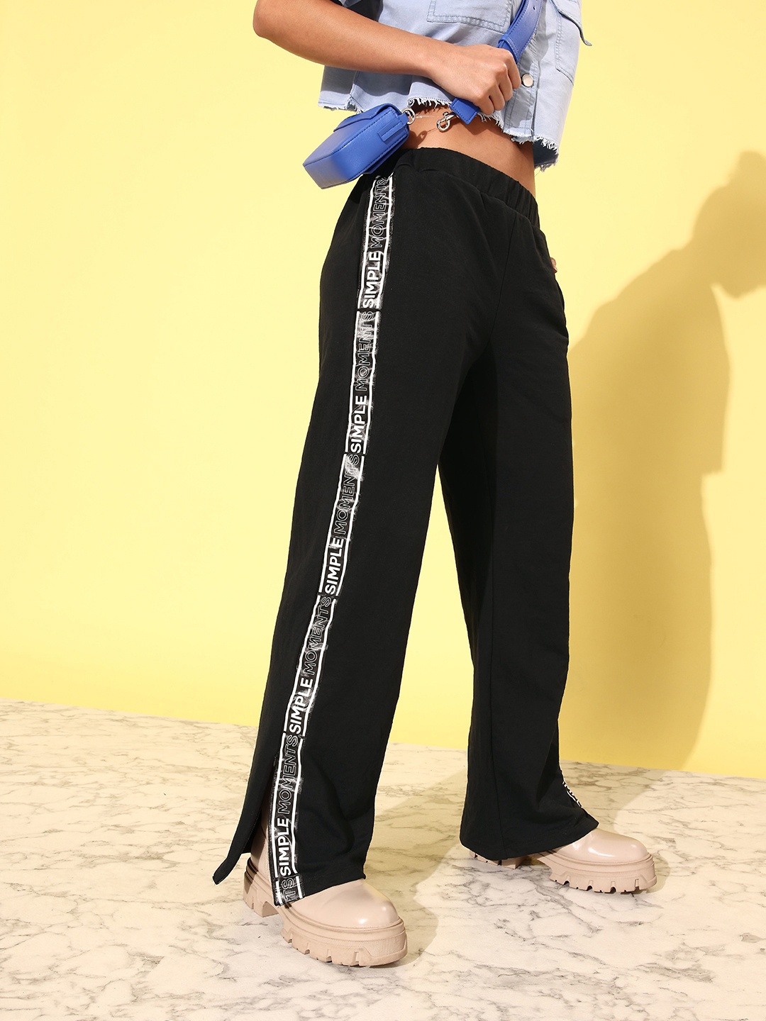 

Kook N Keech Women Bold Black Mid-Rise Wide legs & Flared Track Pants With Side Stripes