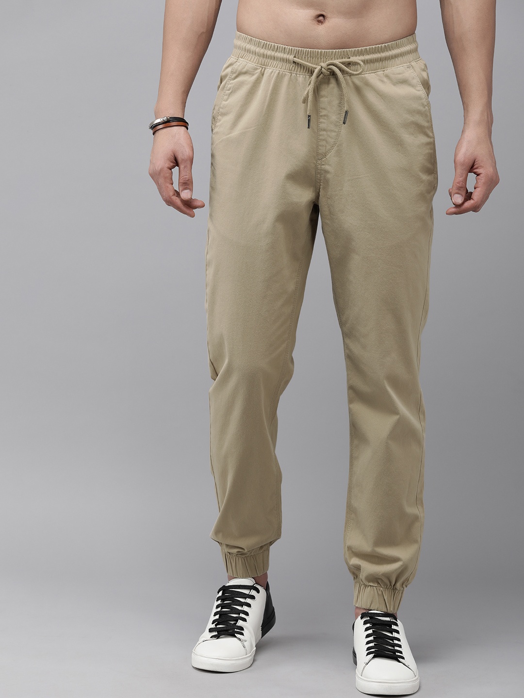 

The Roadster Lifestyle Co. Men Solid Mid Rise Joggers, Beige