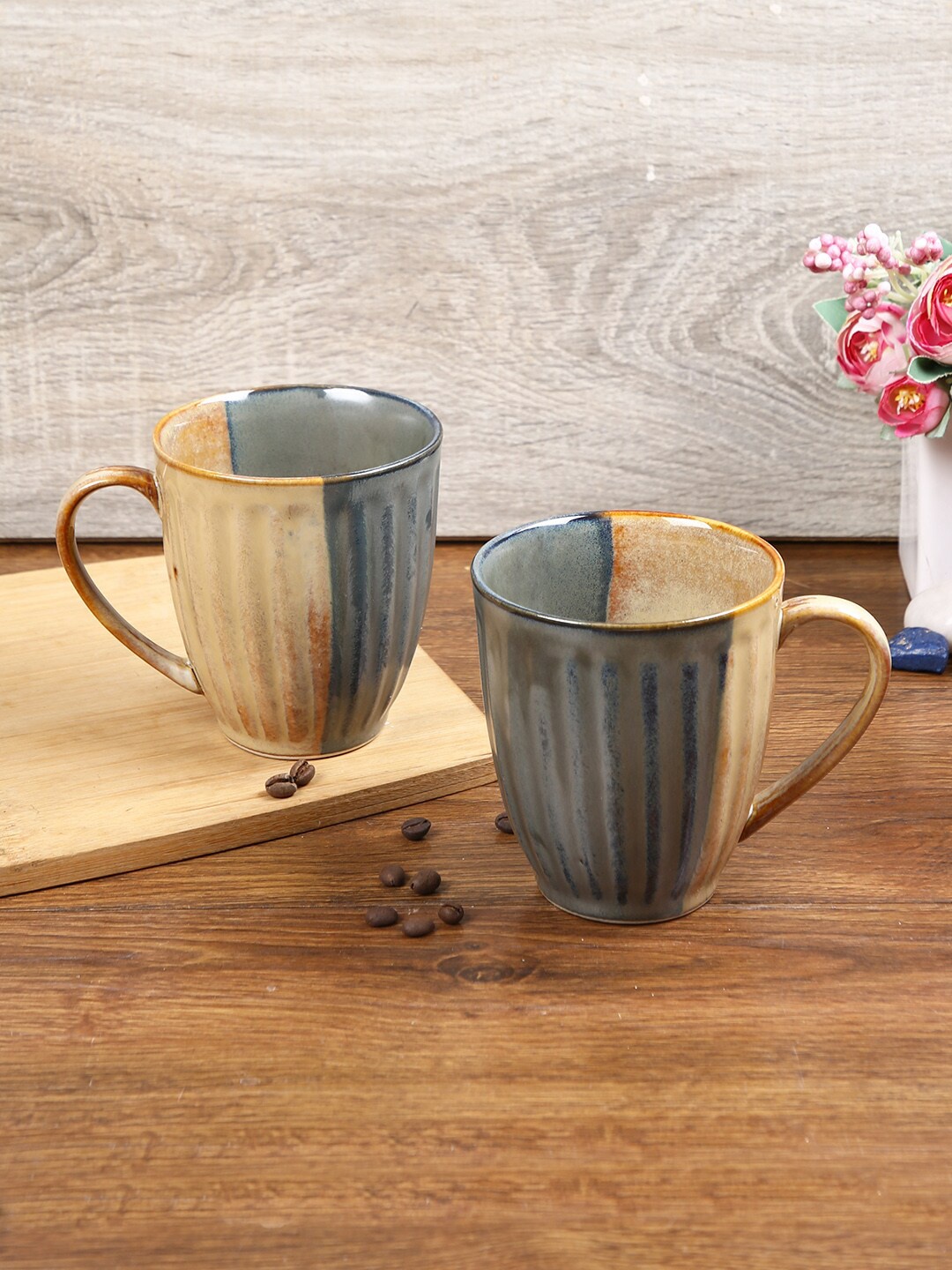 

Aapno Rajasthan Blue & Beige 2 Pcs Textured Color Blocked Ceramic Glossy Mugs 300 Each