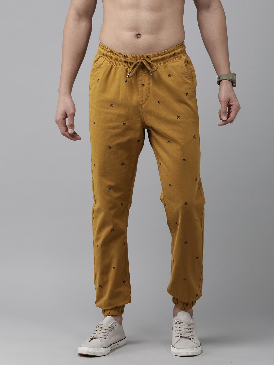 

Roadster Men Pure Cotton Conversational Printed Pleated Joggers Trousers, Mustard