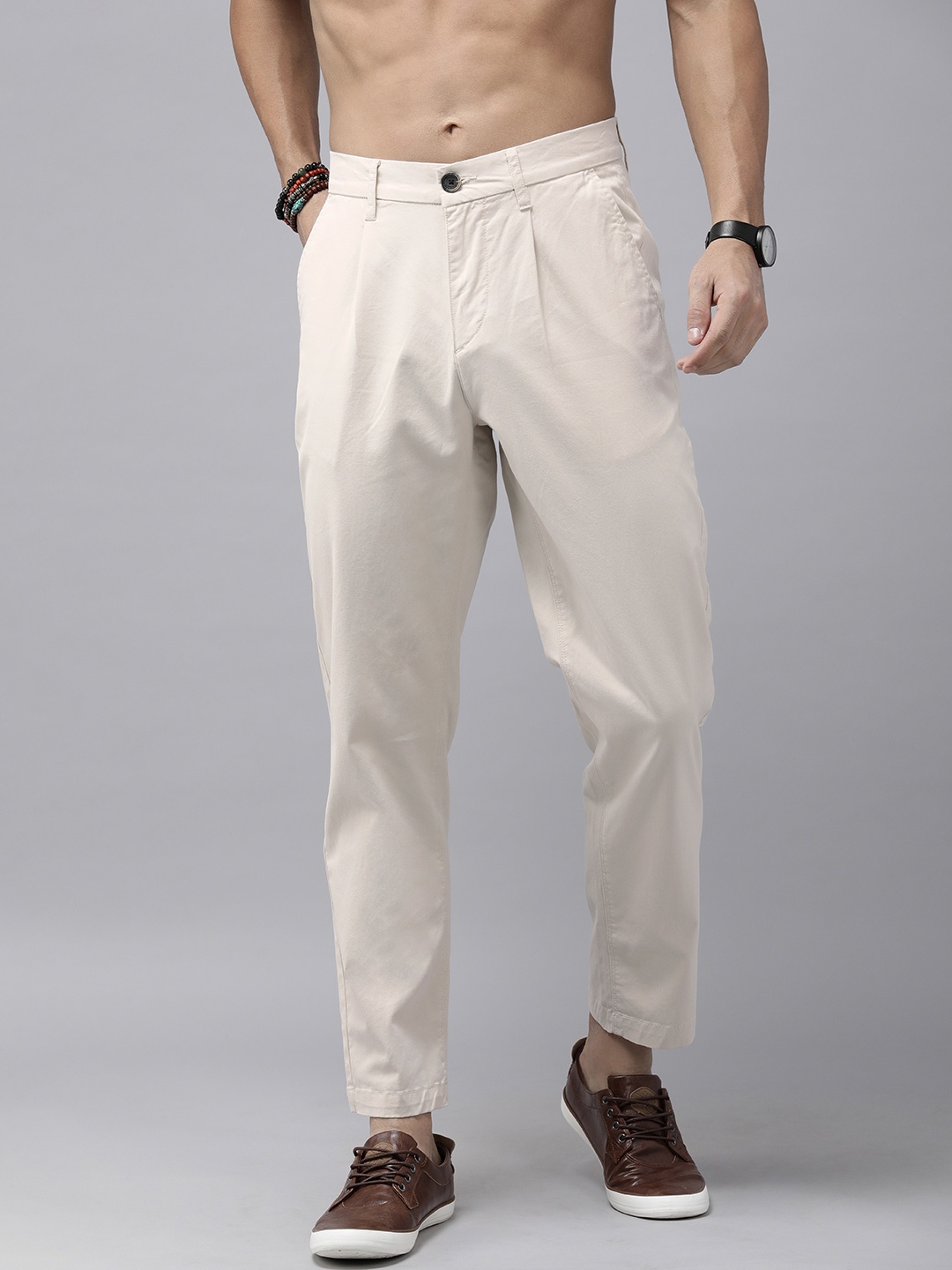 

The Roadster Lifestyle Co. Men Solid Relaxed Fit Pleated Chinos Trousers, Cream