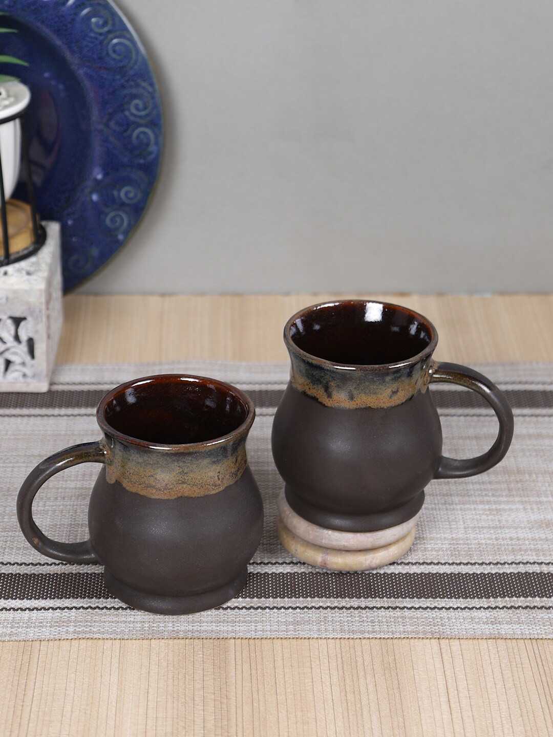 

Aapno Rajasthan 2 Pieces Black & Brown Printed Ceramic Glossy Mugs 300 ml each