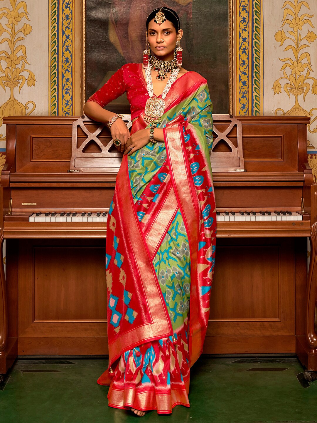 

Anouk Green & Red Ethnic Motifs Zari Silk Blend Ikat Saree