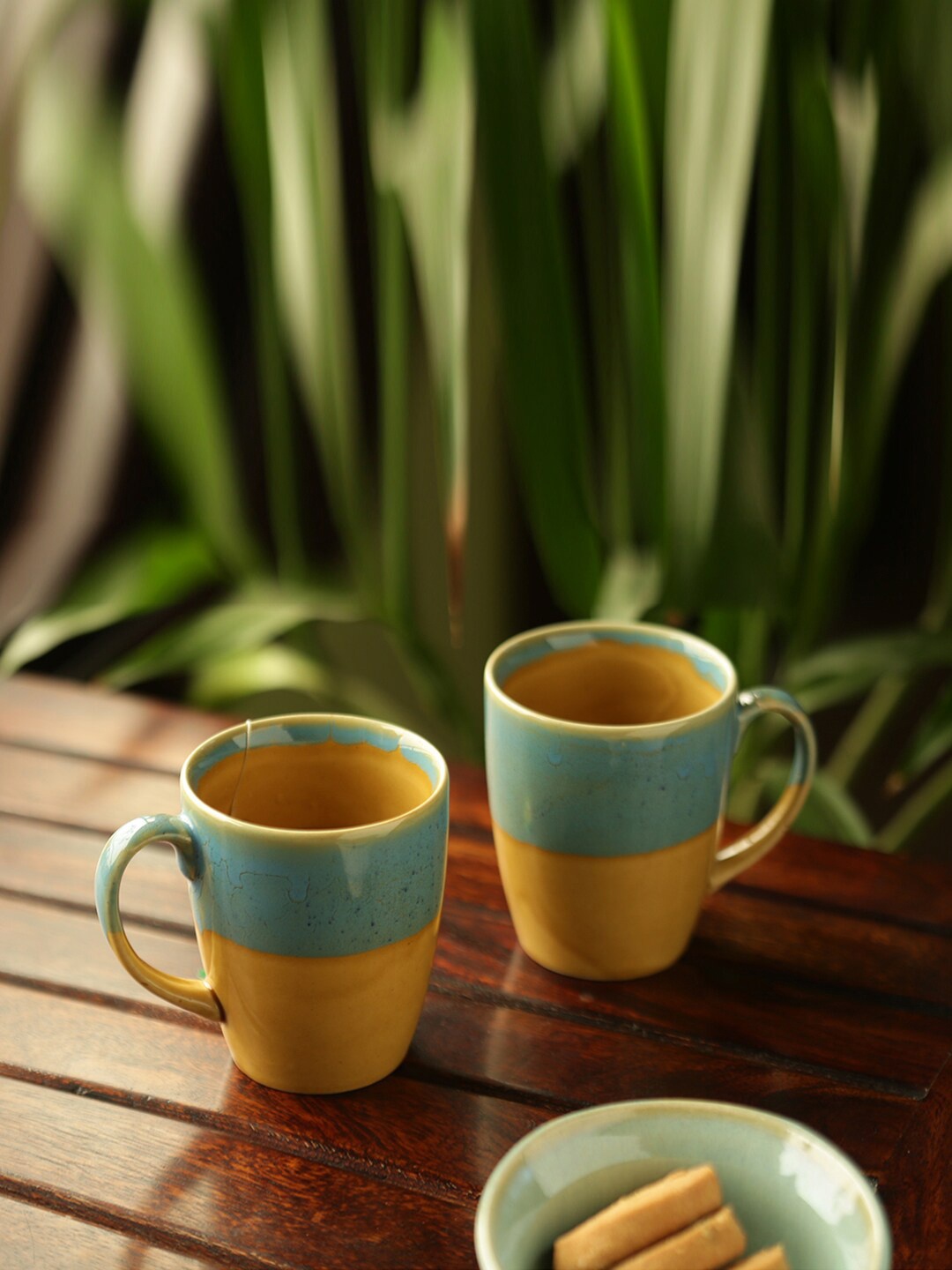 

ExclusiveLane River Rims Yellow & Blue 2 Pcs Color blocked Ceramic Glossy Mugs 330 ml Each