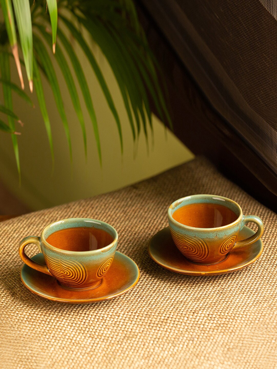 

ExclusiveLane Peacock Boulevard Brown & Sea Green 4 Pcs Ceramic Cups & Saucers 180 ml Each