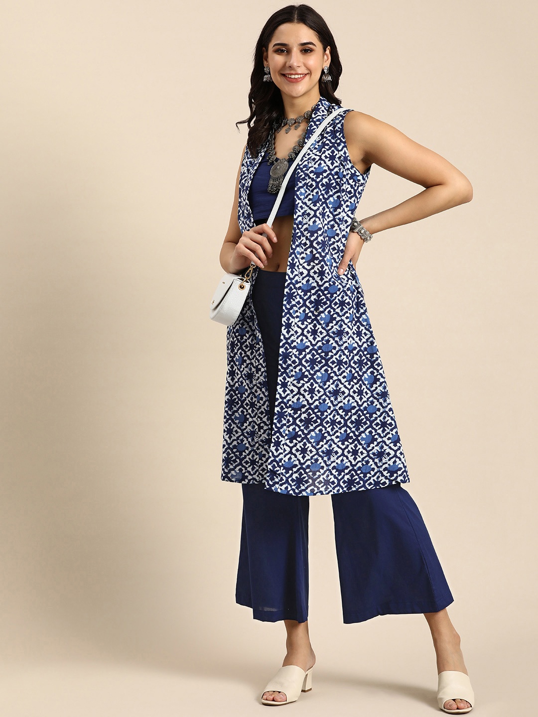 

Sangria Women Solid Crop Top With Palazzos & Printed Shrug Co-ord Set, Navy blue