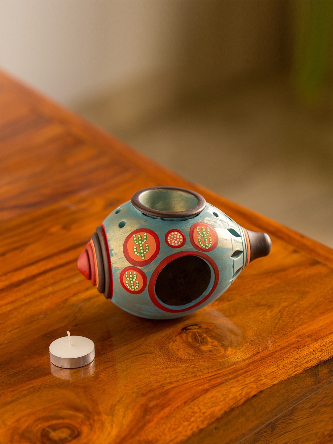 

ExclusiveLane Oasis Shankh Turquoise Blue Hand Cutwork Hand-Painted Terracotta Tea-Light Candle Holder
