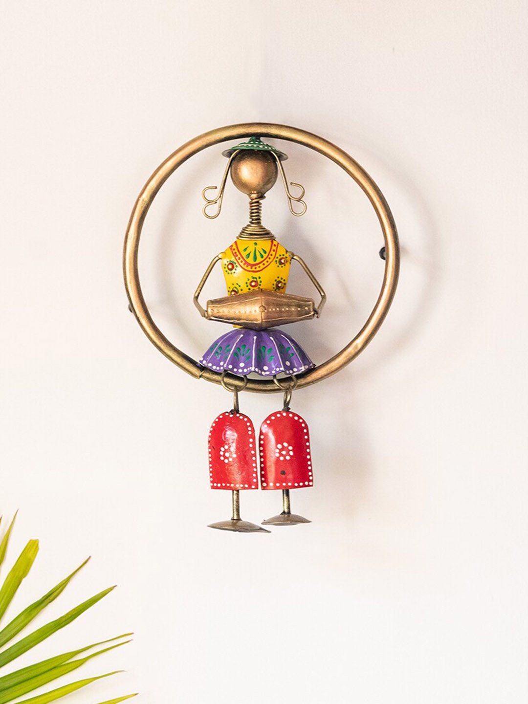 

ExclusiveLane Songs Of The Homeland Gold-Toned & Yellow Printed Hanging Rajasthani Dhol Artist Wall Decor