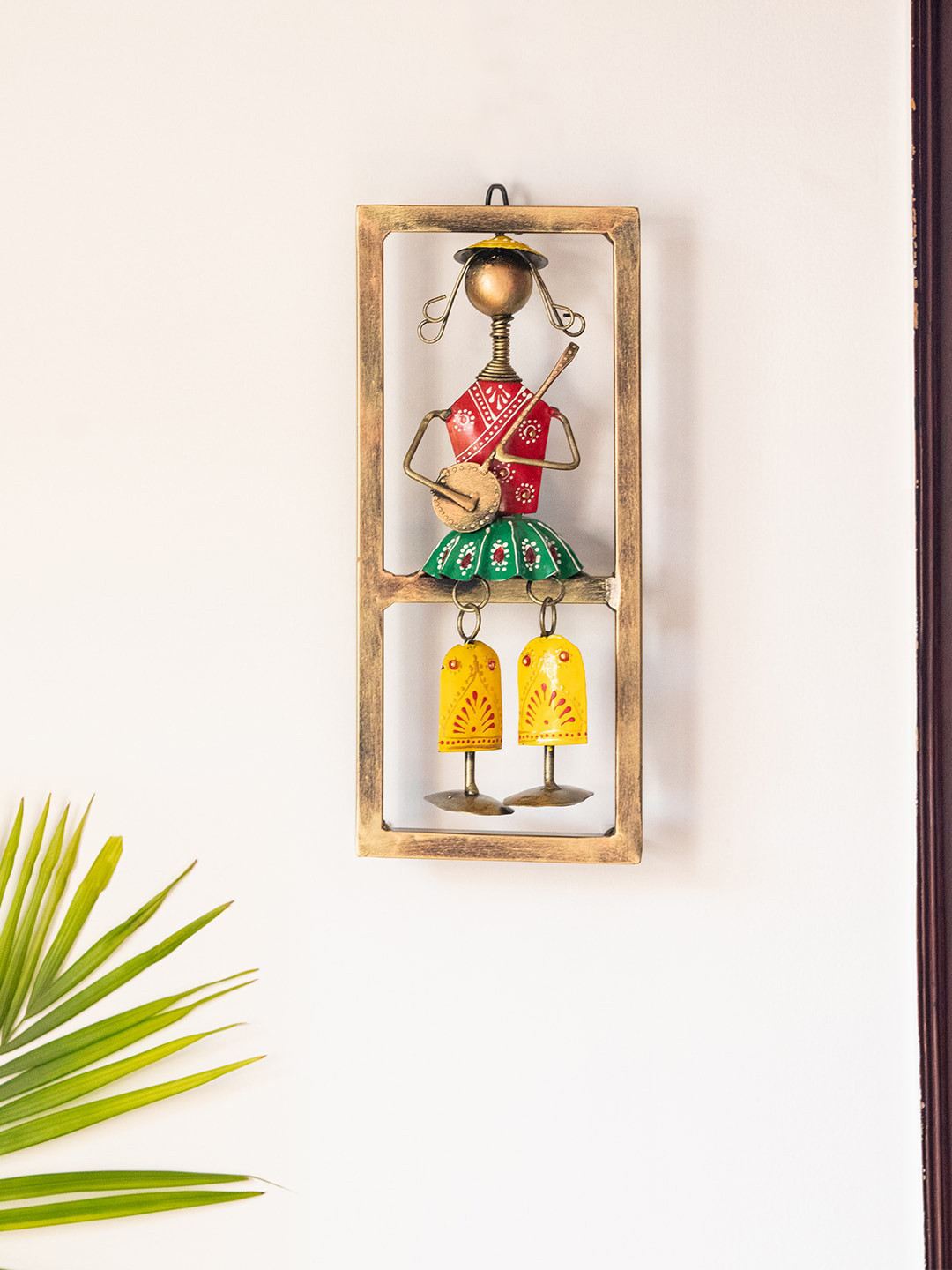 

ExclusiveLane Songs Of The Homeland Gold-Toned & Red Textured Rajasthani Sitar Artist Hanging Wall Decor